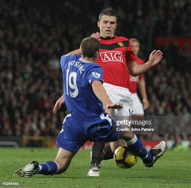 Michael Carrick of Manchester United clashes with Dan Gosling of Everton during the FA Barclays Premier League match between Manchester United and...