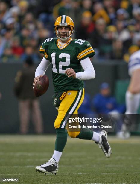 Aaron Rodgers of the Green Bay Packers rolls out to look for a receiver against the Dallas Cowboys at Lambeau Field on November 15, 2009 in Green...