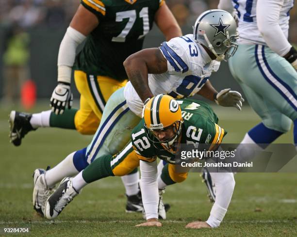 Aaron Rodgers of the Green Bay Packers is knocked down after passing by Anthony Spencer of the Dallas Cowboys at Lambeau Field on November 15, 2009...