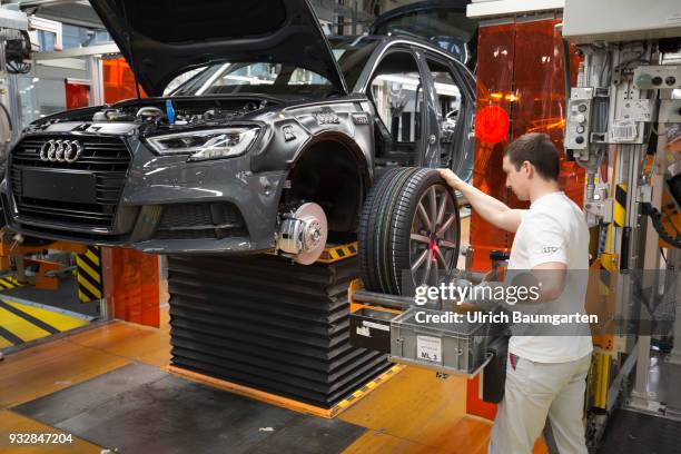 Car production at Audi AG in Ingolstadt. Wheel assembly on the Audi A3/Q2.