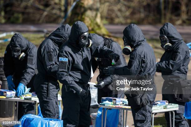 Police officers in protective suits and masks work near the scene where former double-agent Sergei Skripal and his daughter, Yulia were discovered...