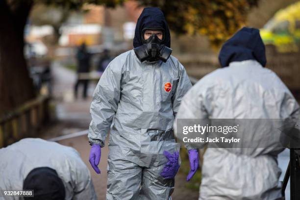 Police officers in protective suits and masks work near the scene where former double-agent Sergei Skripal and his daughter, Yulia were discovered...