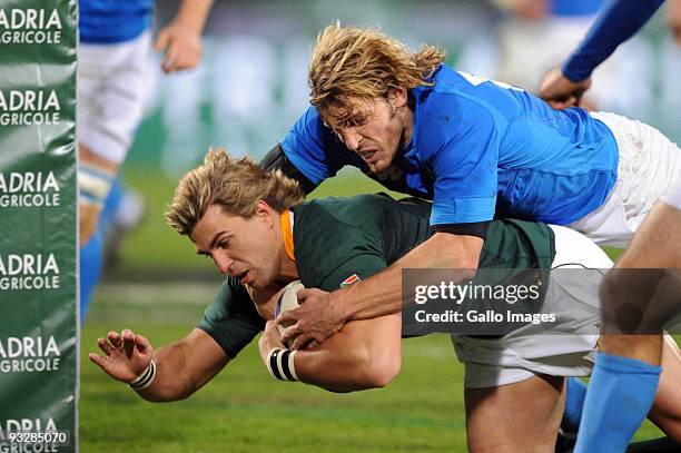 Mirco Bergamasco of Italy fails to stop Wynand Olivier of South Africa from scoring a try during the International match between Italy and South...