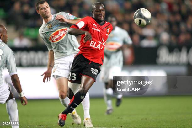 Rennes's forward Asamoah Gyan vies with Le Mans's defender Gregory Cerdan during their French L1 football match Rennes vs. Le Mans, on November 21,...