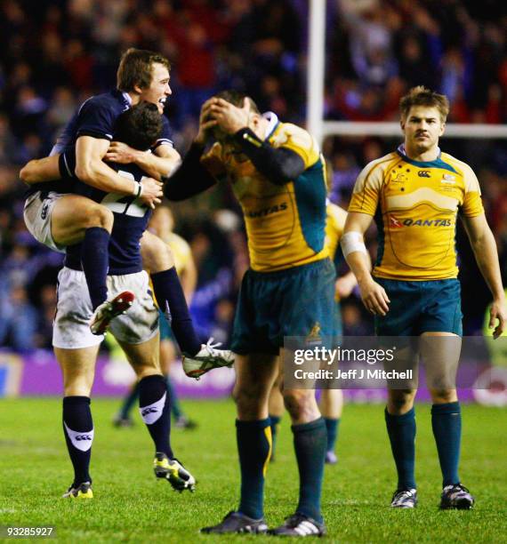 Alex Grove and Nic de Luca celebrate as Matt Giteau of Australia reacts to his missed conversion during the Bank Of Scotland Corporate Autumn Tests...