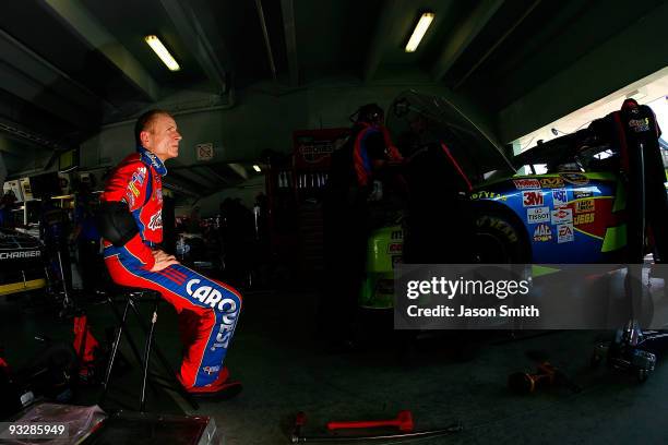 Mark Martin , driver of the Kellogg's/CARQUEST Chevrolet, sits in the garage as crew members work on his car in the garage during practice for the...