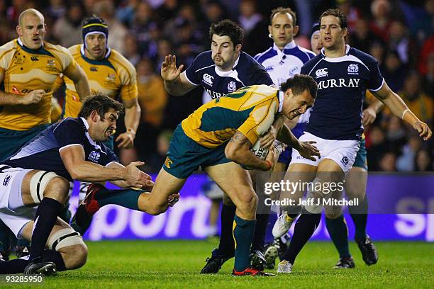 Quade Cooper of Australia is tackled by Nathan Hines and John Barclay of Scotland during the Bank Of Scotland Corporate Autumn Tests match between...