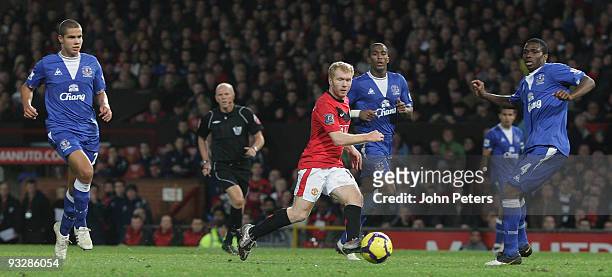 Paul Scholes of Manchester United clashes with Sylvain Distin of Everton during the FA Barclays Premier League match between Manchester United and...