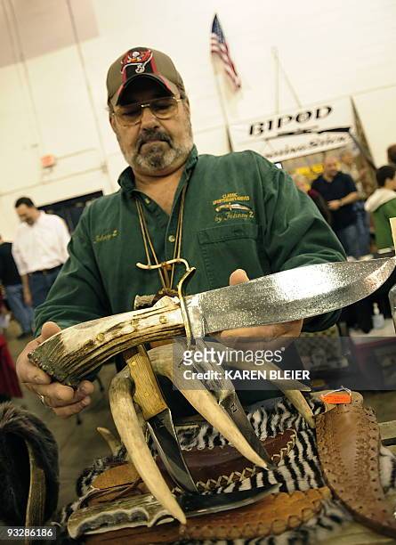 John Zogorean displays a Bowie knife he made that is for sale at the Nations Gunshow on November 21, 2009 in Chantilly, Virginia. Vendors and...