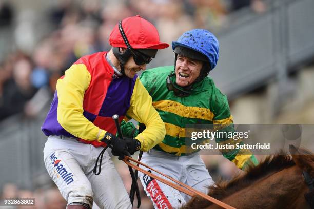Richard Johnson on Native River is congratulated by Barry Geraghty on Anibale Fly after winning the Timico Cheltenham Gold Cup Chase at the...
