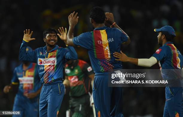 Sri Lankan cricketer Akila Dananjaya celebrates with teammates after he dismissing Bangladesh cricketer Liton Das during the sixth Twenty20...