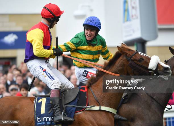 Cheltenham , United Kingdom - 16 March 2018; Jockey Richard Johnson, left, is congradulated by Barry Geraghty after winning the Timico Cheltenham...