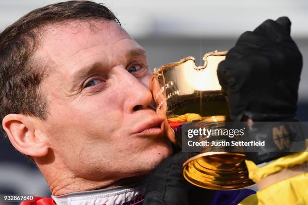 Richard Johnson kisses the Gold Cup after riding Native River to victory in the Timico Cheltenham Gold Cup Chase at the Cheltenham Festival at...