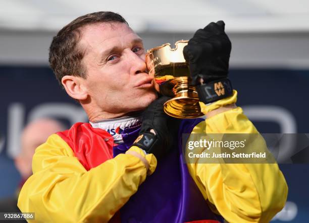 Richard Johnson kisses the Gold Cup after riding Native River to victory in the Timico Cheltenham Gold Cup Chase at the Cheltenham Festival at...