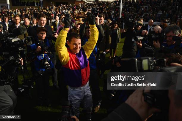 Richard Johnson holds the Gold Cup after riding Native River to victory in the Timico Cheltenham Gold Cup Chase at the Cheltenham Festival at...