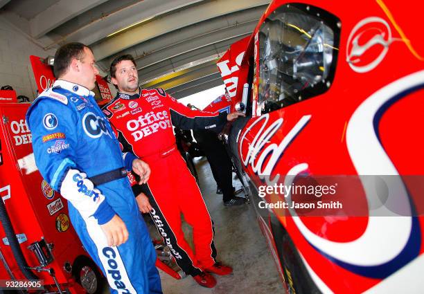 Tony Stewart , driver of the Office Depot/Old Spice Chevrolet, talks with teammate Ryan Newman, driver of the US ARMY All-American Bowl Chevrolet, in...