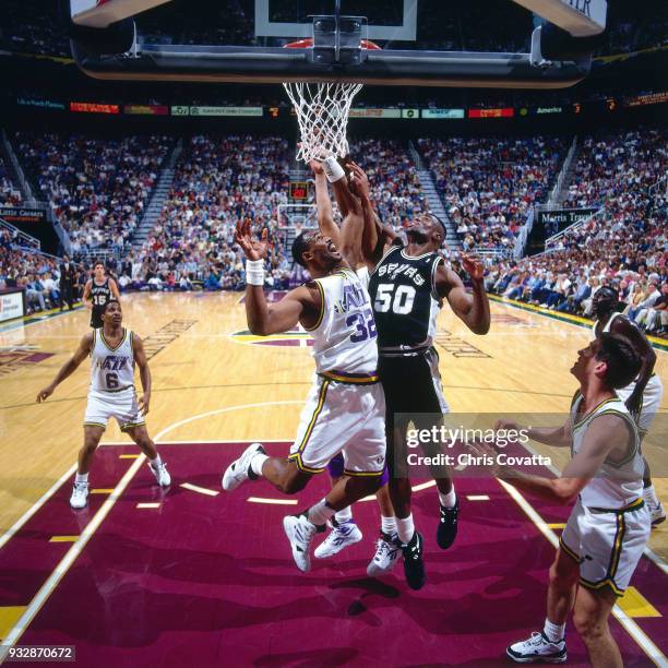 David Robinson of the San Antonio Spurs shoots during Game Three of the First Round of the 1994 NBA Playoffs on May 3, 1994 at the Delta Center in...