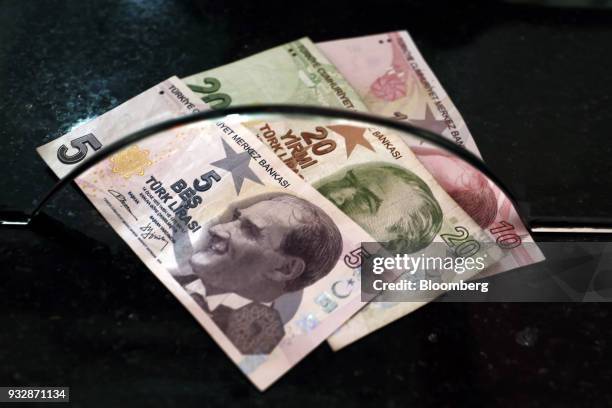 Turkish lira banknotes sit in this arranged photograph at a currency exchange in Istanbul, Turkey, on Friday, March 16, 2018. As Turkish markets...