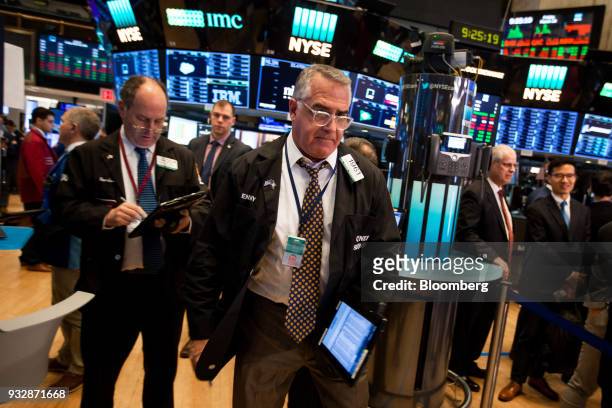 Traders work on the floor of the New York Stock Exchange in New York, U.S., on Friday, March 16, 2018. U.S. Stocks broke out of their four-day slump...