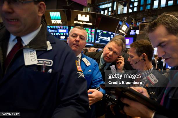 Traders work on the floor of the New York Stock Exchange in New York, U.S., on Friday, March 16, 2018. U.S. Stocks broke out of their four-day slump...