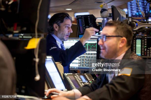 Traders work on the floor of the New York Stock Exchange in New York, U.S., on Friday, March 16, 2018. U.S. Stocks broke out of their four-day slump...