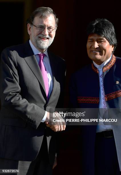 Spanish Prime Minister Mariano Rajoy shakes hands with Bolivian President Evo Morales during a meeting at the Moncloa Palace in Madrid on March 16,...