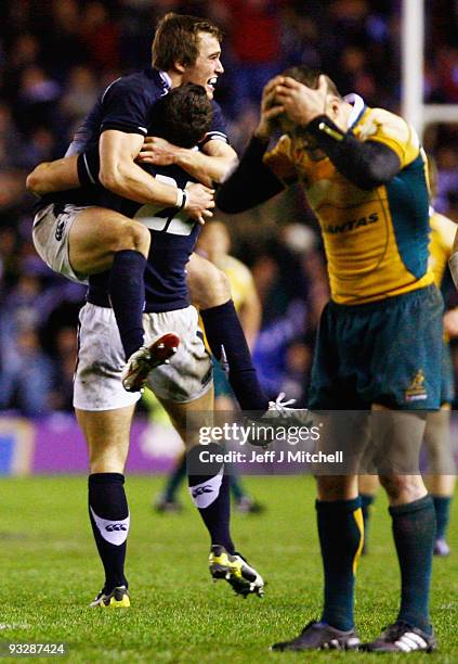 Alex Grove and Nic de Luca of Scotland celebrate as Matt Giteau of Australia reacts to his missed conversion during the Bank Of Scotland Corporate...