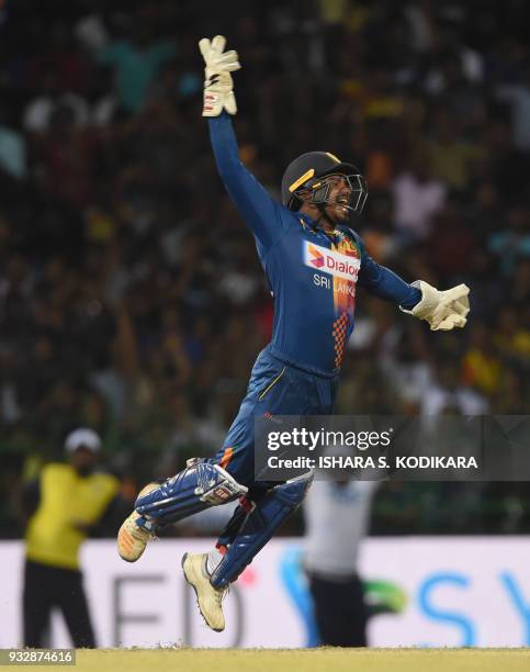 Sri Lankan wicketkeeper Kusal Perera celebrates taking a catch to dismiss Bangladesh cricketer Tamim Iqbal during the sixth Twenty20 international...