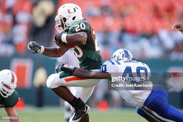 Matt Daniels of the Duke Blue Devils attempts to tackle Damien Berry of the Miami Hurricanes as he runs with the ball on November 21, 2009 at Land...