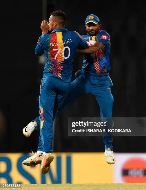 Sri Lankan cricketer Amila Aponsu and Danushka Gunathilaka celebrates after dismissing Bangladesh cricketer Tamim Iqbal during the sixth Twenty20...