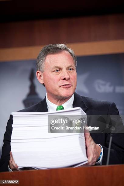 Sen. George LeMieux holds a copy of the Senate's health care legislation while speaking at a news conference regarding the bill on Capitol Hill on...