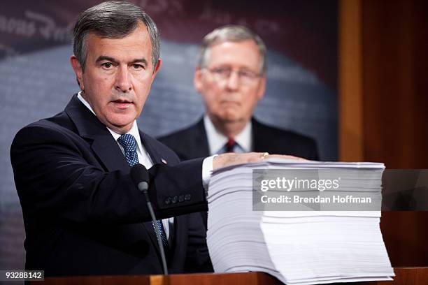 Sen. Mike Johanns gestures to a copy of the Senate's health care reform legislation wihle speaking at a news conference on Capitol Hill on November...