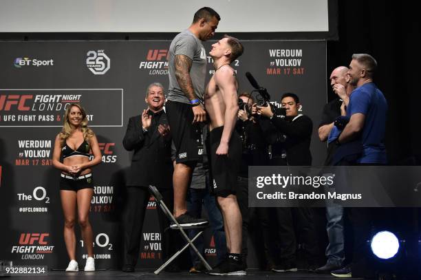 Fabricio Werdum of Brazil and Alexander Volkov of Russia face off during the UFC Fight Night weigh-in inside The O2 Arena on March 16, 2018 in...