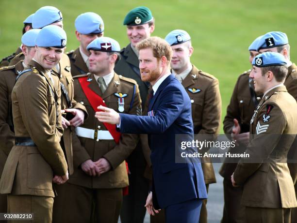 Prince Harry presents 12 pilots from Course 17/02 of the Army Air Corps with their Wings during a ceremony at Museum of Army Flying in Stockbridge,...