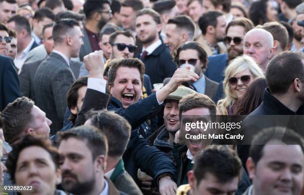 Racegoers react as they watch the St. James's Place Foxhunter Steeple Chase Challenge Cup at Cheltenham Racecourse on Gold Cup Day on March 16, 2018...