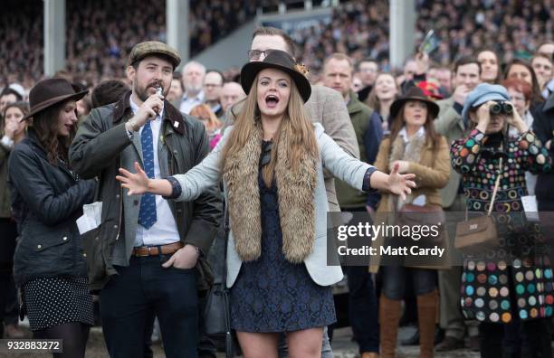 Racegoers react as they watch the racing in the Gold Cup at Cheltenham Racecourse on Gold Cup Day on March 16, 2018 in Cheltenham, England. Thousands...