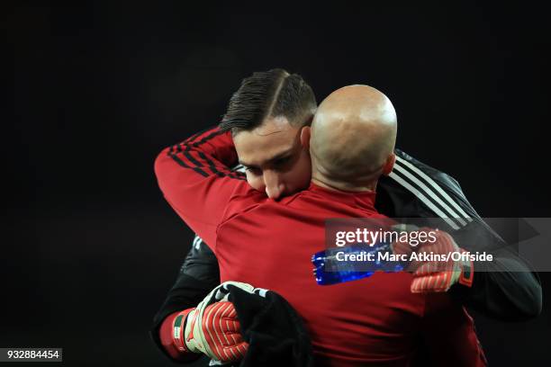 Gianluigi Donnarumma of AC Milan embraces goalkeeping coach Alfredo Magni during the UEFA Europa League Round of 16 2nd leg match between Arsenal and...