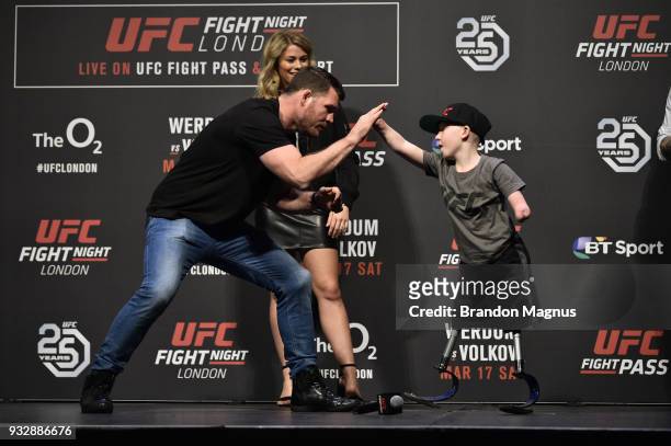 Middleweight Michael Bisping interacts with UFC fan Marshall Jensen during a Q&A session after the UFC Fight Night weigh-in inside The O2 Arena on...