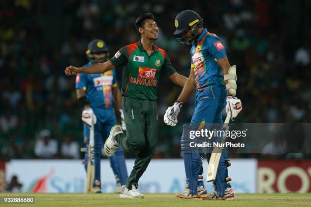 Bangladesh cricketer Mustafizur Rahman celebrates after taking the wicket of Sri Lankan cricketer Dasun Shanaka during the 6th T20 cricket match of...