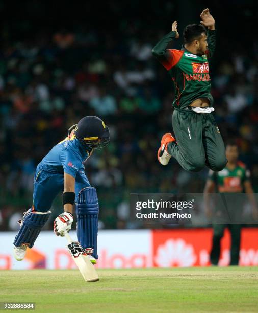 Bangladesh cricket captain Shakib Al Hasan leaps in the air as Sri Lanka's Kusal Mendis completes a run during the 6th T20 cricket match of NIDAHAS...