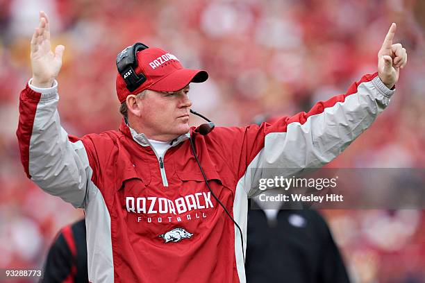 Head Coach Bobby Petrino of the Arkansas Razorbacks calls in a play from the sidelines against the Mississippi State Bulldogs at War Memorial Stadium...