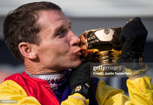 Richard Johnson holds the Gold Cup after riding Native River to victory in the Timico Cheltenham Gold Cup Chase at the Cheltenham Festival at...