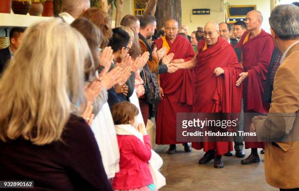 Tibetan spiritual leader the Dalai Lama greets devotees as he arrives to attend the last day of the Mind and Life 33rd conference at the main...