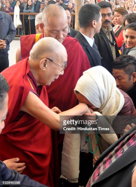 Tibetan spiritual leader the Dalai Lama greets devotees as he arrives to attend the last day of the Mind and Life 33rd conference at the main...