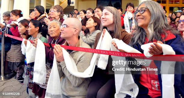 Tibetan spiritual leader the Dalai Lama greets devotees as he arrives to attend the last day of the Mind and Life 33rd conference at the main...