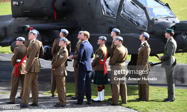 Prince Harry watches a fly-past with Army Air Corps pilots after presenting Wings during a ceremony at Museum of Army Flying in Stockbridge, England.