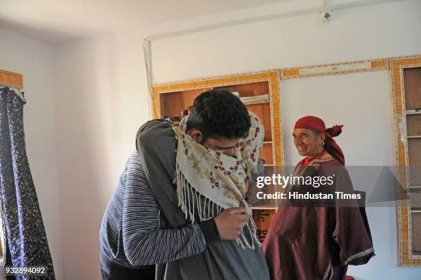 Woman hugs Kamran Yousuf a Kashmiri photojournalist who was released on bail this week six months after his arrest by the National Investigation...