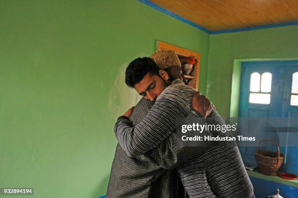 Man hugs Kamran Yousuf a Kashmiri photojournalist who was released on bail this week six months after his arrest by the National Investigation Agency...
