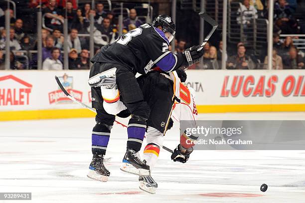Dustin Brown of the Los Angeles Kings checks Curtis Glencross of the Calgary Flames at Staples Center on November 21, 2009 in Los Angeles, California.