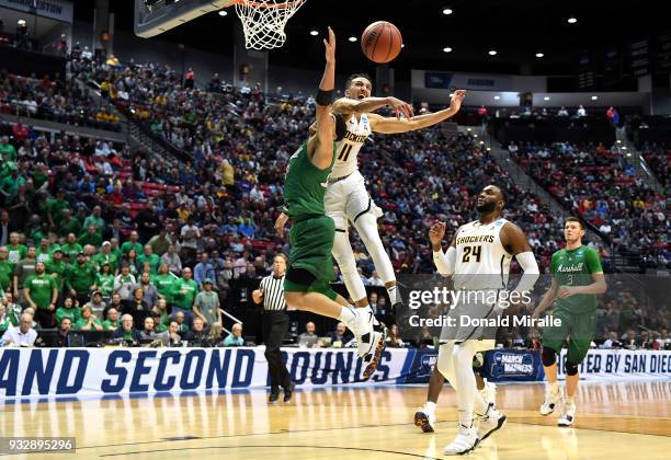 Landry Shamet of the Wichita State Shockers blocks a shot by Jarrod West of the Marshall Thundering Herd in the second half during the first round of...